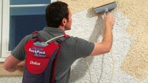 Man painting wall with Dulux paint